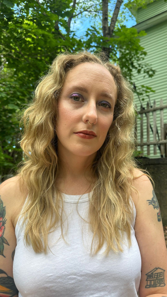 sunny photo of woman sitting outside with eye shadow on